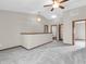 Open and airy living room featuring carpeted floors and multiple entrances to the rest of the home at 878 Hollowood Ln, Avon, IN 46123
