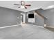 Carpeted living room with a ceiling fan, tv, access to the stairs and sliding doors at 878 Hollowood Ln, Avon, IN 46123