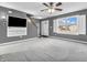 A comfortable living room features a large window, wall-mounted tv, and access to the stairs at 878 Hollowood Ln, Avon, IN 46123