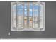 The view through open shutters reveals the neighborhood outside this lovely home at 878 Hollowood Ln, Avon, IN 46123