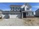 Charming two-story home with blue siding, white trim, and a spacious three-car garage at 8915 Alexander Rdg, McCordsville, IN 46055