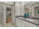 Bright bathroom featuring a dual sink vanity with framed mirror and a large walk-in closet at 8931 Alexander Ridge Dr, McCordsville, IN 46055