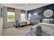 Stylish bedroom featuring a blue accent wall, two twin beds and bright windows with a view at 8931 Alexander Ridge Dr, McCordsville, IN 46055