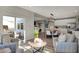 Sunlit living room showcases an open floor plan with stylish decor and patio access at 8931 Alexander Ridge Dr, McCordsville, IN 46055