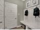 Convenient mudroom entry featuring a bench, hooks, and door to the home at 8931 Alexander Ridge Dr, McCordsville, IN 46055