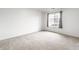 A bright bedroom with a window providing natural light and neutral carpeting, creating a cozy atmosphere at 9820 Legends Creek Dr # 103, Indianapolis, IN 46229