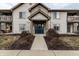 Charming condo exterior with a blue entry door, covered entrance, and well-maintained landscaping at 9820 Legends Creek Dr # 103, Indianapolis, IN 46229