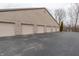 Row of garages with individual doors, providing ample parking space and storage in a brick building at 9820 Legends Creek Dr # 103, Indianapolis, IN 46229