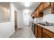 Well-lit kitchen featuring stainless steel appliances and warm-toned wooden cabinetry at 9820 Legends Creek Dr # 103, Indianapolis, IN 46229