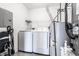 Bright laundry room with a modern washer and dryer set, plus a water heater and utility connections at 9820 Legends Creek Dr # 103, Indianapolis, IN 46229
