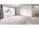 Spacious living room with sliding glass doors to a patio area at 9820 Legends Creek Dr # 103, Indianapolis, IN 46229