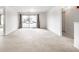 Bright and airy living room featuring plush carpeting and a sliding glass door to a patio at 9820 Legends Creek Dr # 103, Indianapolis, IN 46229