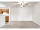Open concept living room featuring plush carpet, natural lighting, and views of the kitchen at 9820 Legends Creek Dr # 103, Indianapolis, IN 46229