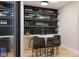Stylish bar area with glass-enclosed wine storage, marble countertop, seating, and ample storage at 124 1St. Se Ave, Carmel, IN 46032