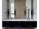 Modern bathroom featuring a double vanity, decorative mirrors, and elegant fixtures at 124 1St. Se Ave, Carmel, IN 46032