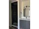 Chic bathroom boasts a glass-enclosed shower with dark tile and modern vanity with globe sconces at 124 1St. Se Ave, Carmel, IN 46032