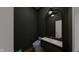 Sleek powder room with a dark accent wall, designer mirror, modern fixtures, and stylish vanity at 124 1St. Se Ave, Carmel, IN 46032