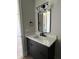 Modern bathroom vanity features a sleek countertop, dark cabinetry, and contemporary fixtures at 124 1St. Se Ave, Carmel, IN 46032