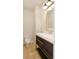 Chic half bathroom with a modern vanity, gold hardware, wood-look flooring, and ample lighting at 124 1St. Se Ave, Carmel, IN 46032