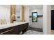 Elegant bathroom with dual sinks, modern fixtures, decorative mirrors, and a tiled shower at 124 1St. Se Ave, Carmel, IN 46032