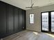 Stylish bedroom with hardwood floors, modern lighting, and access to a balcony at 124 1St. Se Ave, Carmel, IN 46032