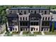 Charming multi-level townhome featuring stone and brick accents, a black roof, and multiple windows for ample natural light at 124 1St. Se Ave, Carmel, IN 46032
