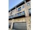 Brick apartment building with black balconies and garage doors on a sunny day at 124 1St. Se Ave, Carmel, IN 46032