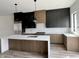 Modern kitchen featuring a large island, stainless steel appliances, sleek cabinets, and quartz countertops at 124 1St. Se Ave, Carmel, IN 46032