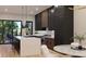 Modern kitchen with stainless steel appliances, large marble island, and dark and wood-colored cabinetry at 124 1St. Se Ave, Carmel, IN 46032