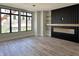 Spacious living room featuring modern fireplace, large windows, and hardwood floors at 124 1St. Se Ave, Carmel, IN 46032