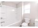 Bright bathroom with tub, white fixtures, and natural light from window at 1305 W 23Rd St, Indianapolis, IN 46208