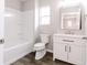 Modern bathroom featuring a tub, toilet, and vanity with sleek fixtures and a mirror at 1305 W 23Rd St, Indianapolis, IN 46208