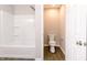 Bathroom with a clean white bathtub, toilet, and modern fixtures, ideal for a refreshing experience at 1305 W 23Rd St, Indianapolis, IN 46208