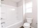 A well lit bathroom with a tub and shower combo, white fixtures, and a toilet at 1305 W 23Rd St, Indianapolis, IN 46208