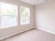 Bright, carpeted bedroom with two windows showcasing natural light at 1305 W 23Rd St, Indianapolis, IN 46208