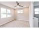 Well-lit bedroom with neutral carpet, ceiling fan, and multiple windows offering natural light at 1305 W 23Rd St, Indianapolis, IN 46208