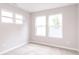 Bright bedroom featuring three windows letting in natural light and neutral carpet at 1305 W 23Rd St, Indianapolis, IN 46208