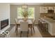 Elegant dining room with modern lighting, adjacent to the kitchen and a decorative electric fireplace at 1305 W 23Rd St, Indianapolis, IN 46208