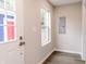 Bright entryway featuring a white door, window, neutral walls, and wood-look flooring at 1305 W 23Rd St, Indianapolis, IN 46208
