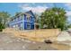 New blue construction with white trim and a red front door is protected by a wooden fence at 1305 W 23Rd St, Indianapolis, IN 46208