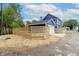 Two-story blue home with attached garage and newly built wooden fence in the backyard at 1305 W 23Rd St, Indianapolis, IN 46208
