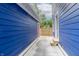 Exterior view of a bright blue home with concrete walkway and newly constructed wood fence at 1305 W 23Rd St, Indianapolis, IN 46208