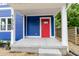 Close up of the front of a blue home featuring a bright red front door and white trim at 1305 W 23Rd St, Indianapolis, IN 46208