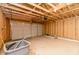Spacious unfinished garage with exposed wood framing and a garage door at 1305 W 23Rd St, Indianapolis, IN 46208