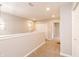 Upstairs hallway features neutral walls, plush carpet, and a view of the lighting fixture at 1305 W 23Rd St, Indianapolis, IN 46208