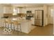 Modern kitchen featuring stainless steel appliances, a breakfast bar, and ample counter space at 1305 W 23Rd St, Indianapolis, IN 46208