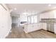 Open-concept kitchen with white cabinets, granite countertops, and stainless steel appliances at 1305 W 23Rd St, Indianapolis, IN 46208