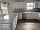 Spacious kitchen featuring an L-shaped layout, gray countertops, and stainless steel appliances at 1305 W 23Rd St, Indianapolis, IN 46208