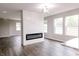 Bright living room featuring a modern fireplace, wood floors, and lots of natural light at 1305 W 23Rd St, Indianapolis, IN 46208