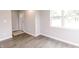 Bright room with light gray walls and wood-look flooring has large windows at 1305 W 23Rd St, Indianapolis, IN 46208